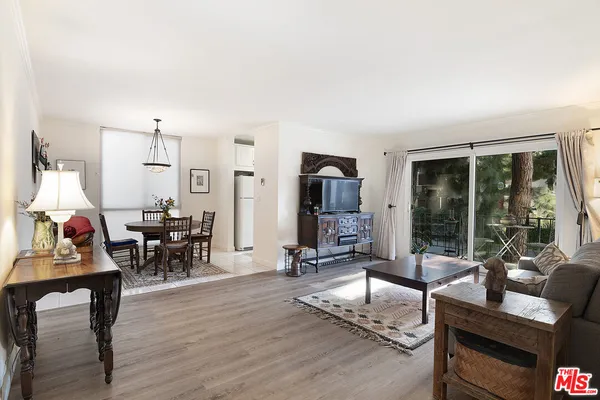 a living room with furniture and large windows