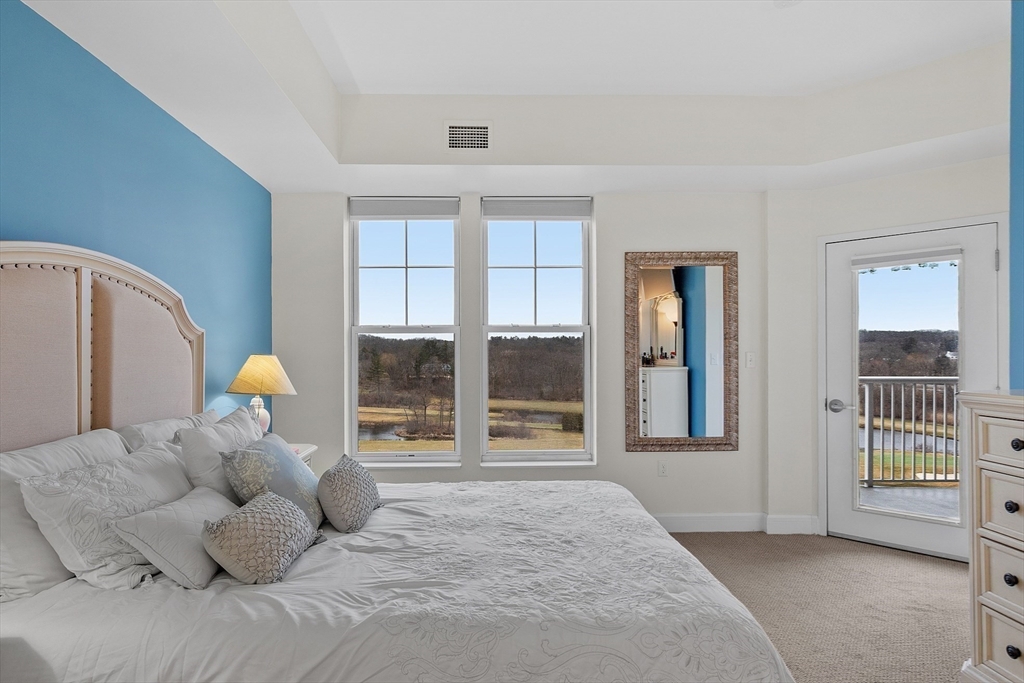 38 Village Road, Unit 602 Middleton, MA 01949 - Photo 20 of 42 a bedroom with a bed and a large window