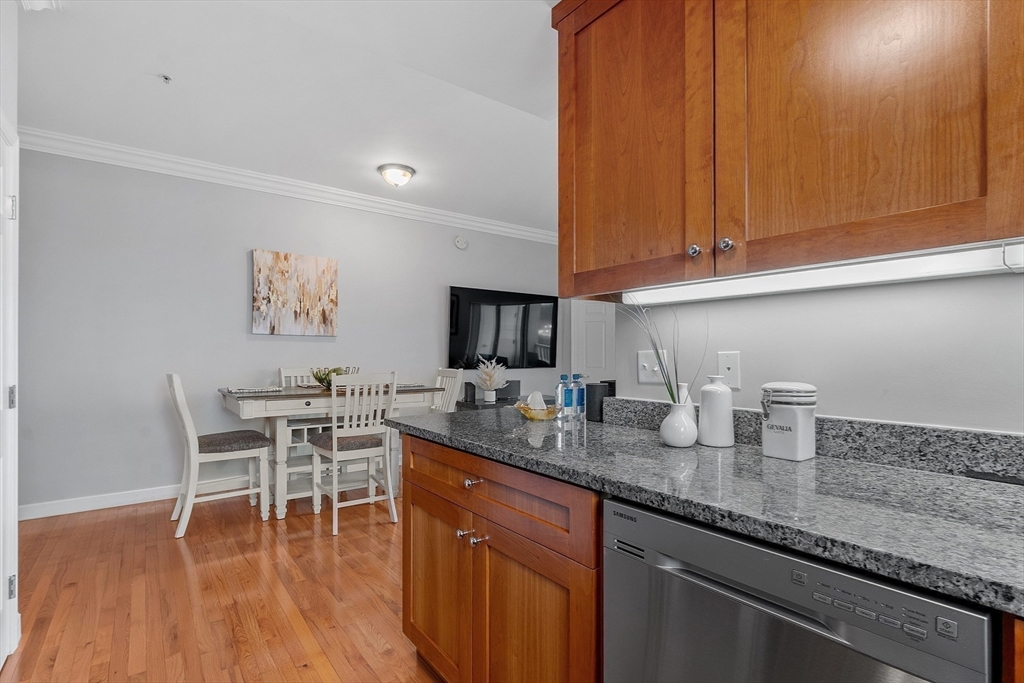 38 Village Road, Unit 602 Middleton, MA 01949 - Photo 10 of 42 a kitchen with granite countertop a sink a stove and cabinets