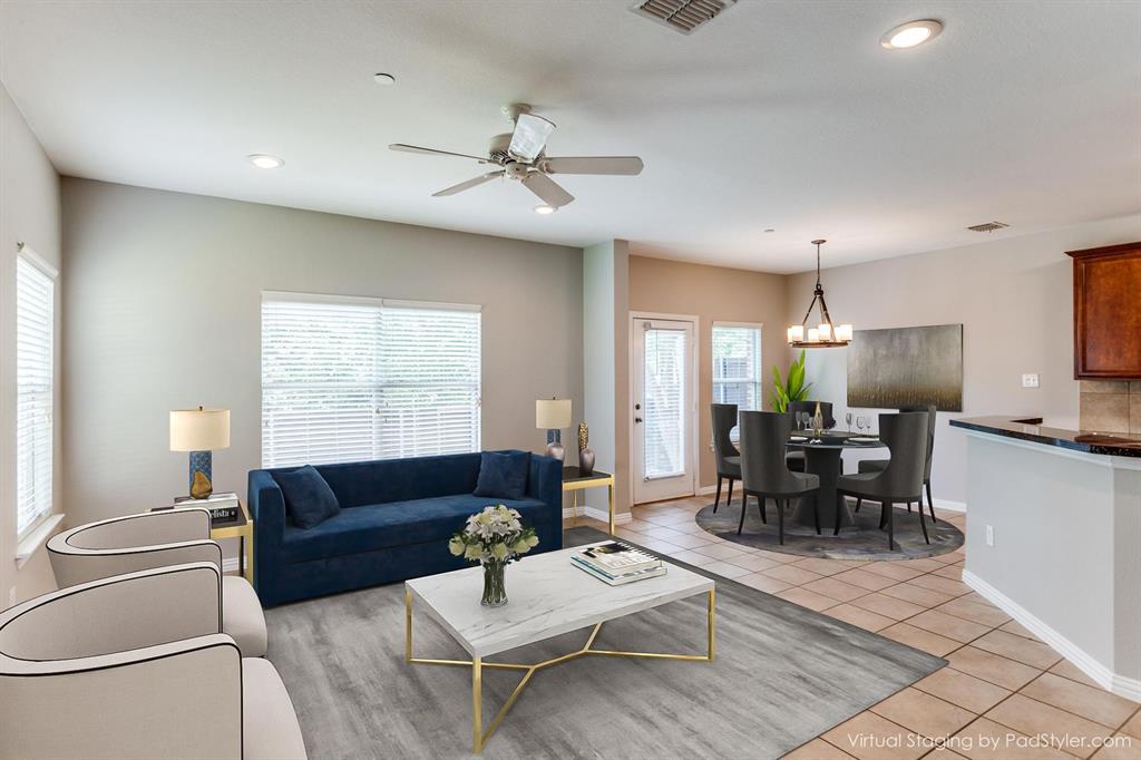 a living room with furniture a dining table and a couch