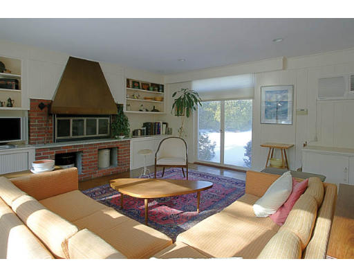 25 Manor House Road Newton, MA 02459 - Photo 5 of 7 a living room with furniture a flat screen tv and a large window