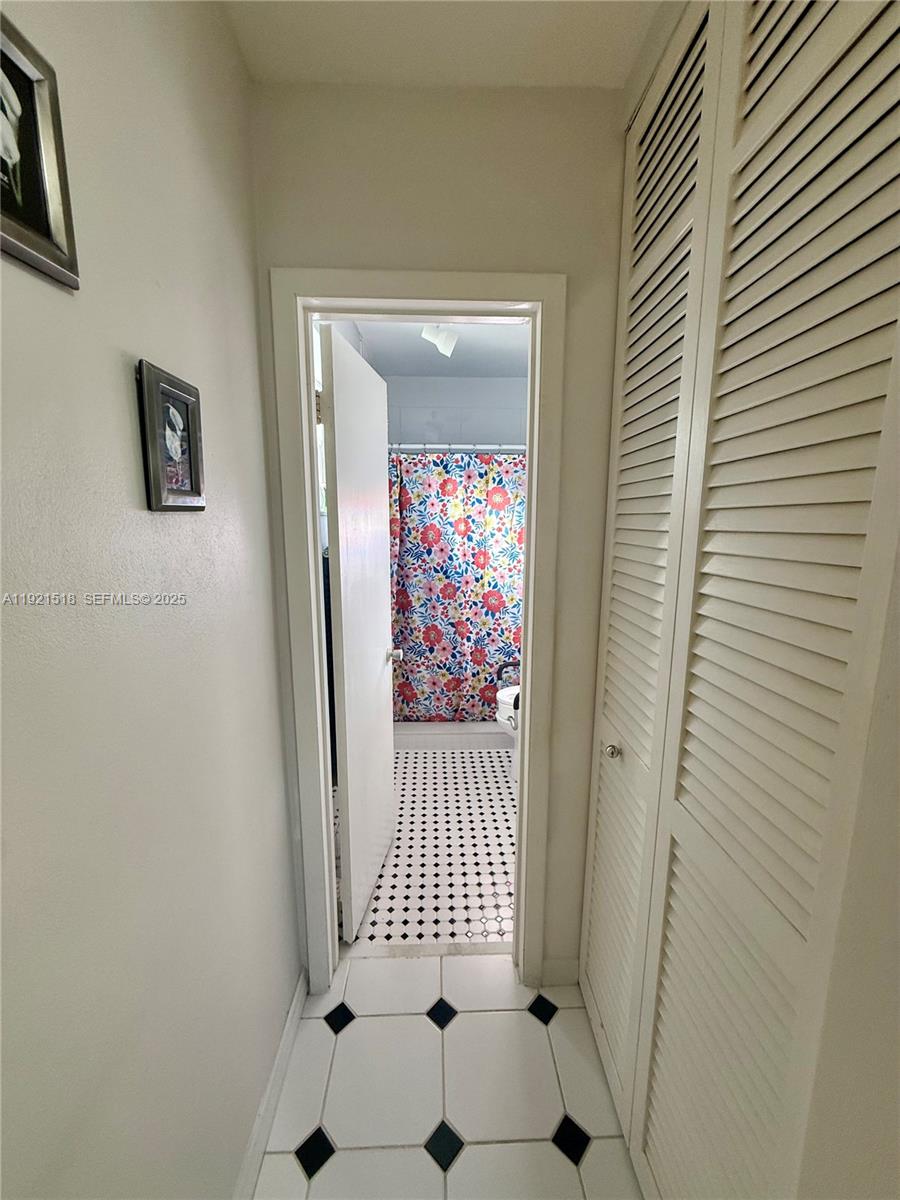 8070 Northwest 176th Street Hialeah, FL 33015 - Photo 12 of 26 a view of a hallway with a door and wooden floor