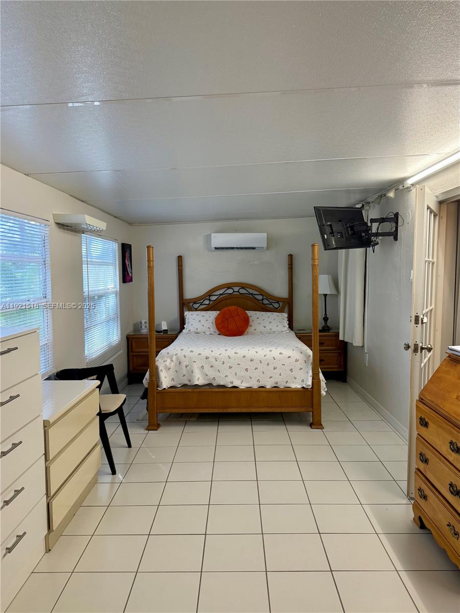 8070 Northwest 176th Street Hialeah, FL 33015 - Photo 16 of 26 a bedroom with a bed and a view of bathroom