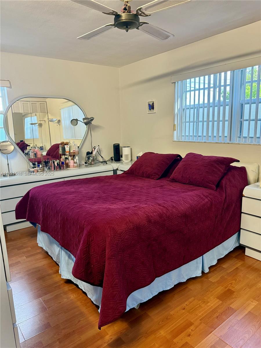 8070 Northwest 176th Street Hialeah, FL 33015 - Photo 18 of 26 a bed sitting in a bedroom next to a window