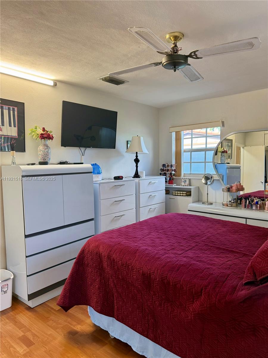 8070 Northwest 176th Street Hialeah, FL 33015 - Photo 19 of 26 a bed room with a bed tv and a window