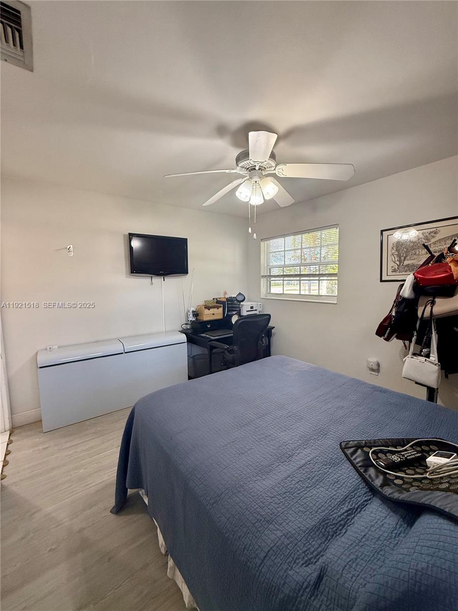 8070 Northwest 176th Street Hialeah, FL 33015 - Photo 21 of 26 a bedroom with a bed and a chandelier