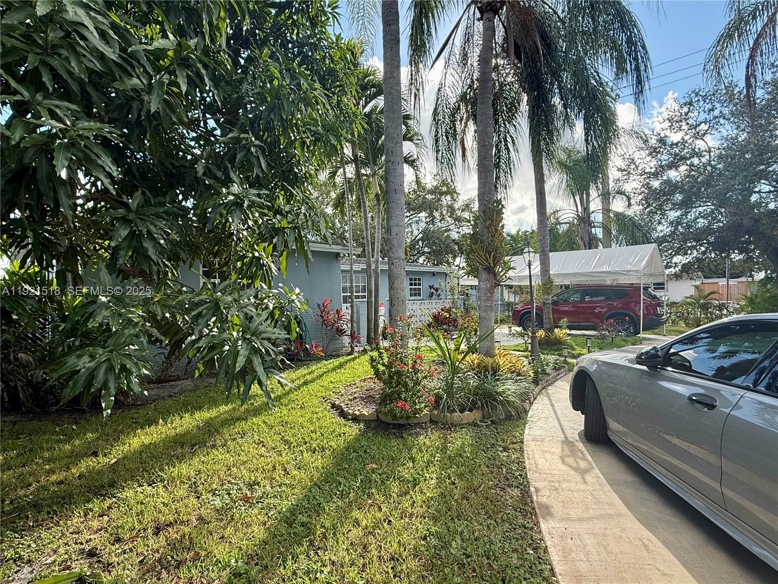 8070 Northwest 176th Street Hialeah, FL 33015 - Photo 4 of 26 a view of a backyard with couches plants and swimming pool