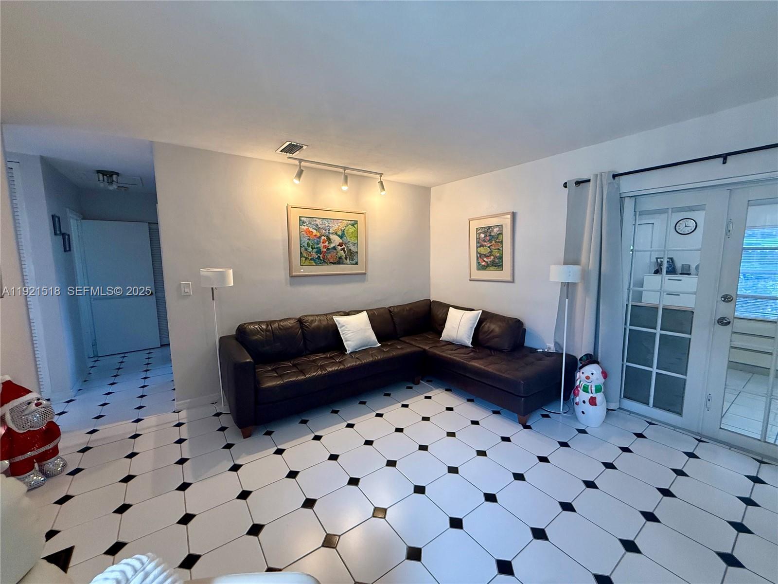 8070 Northwest 176th Street Hialeah, FL 33015 - Photo 6 of 26 a living room with a couch and a rug