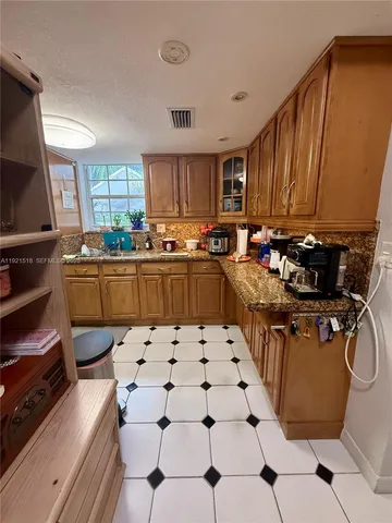 a kitchen with a sink a stove a microwave and cabinets