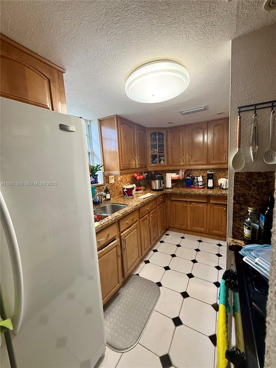 8070 Northwest 176th Street Hialeah, FL 33015 - Photo 9 of 26 a kitchen with stainless steel appliances a refrigerator sink and cabinets
