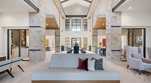 a living room with fireplace furniture and a large window