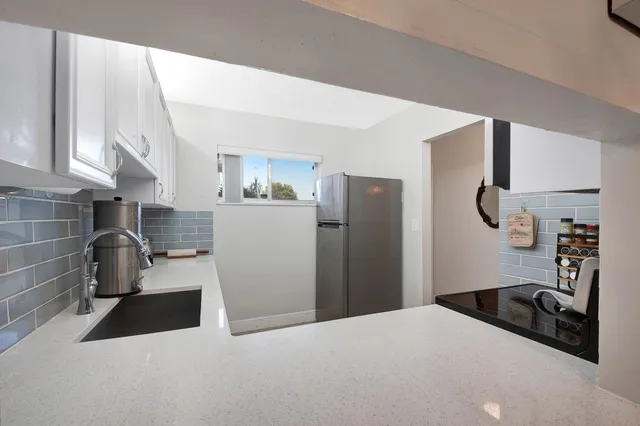 a kitchen with a refrigerator and a sink