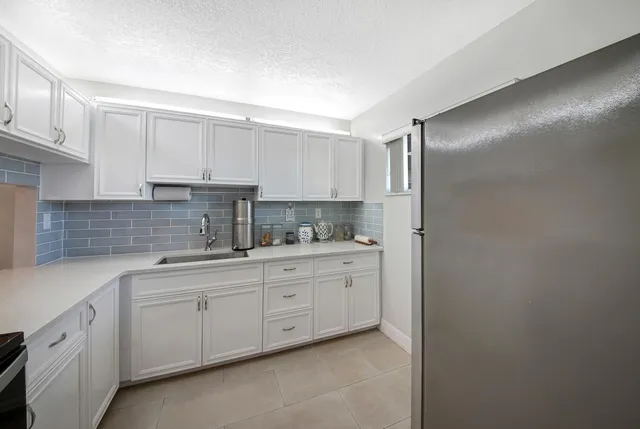 a kitchen with white cabinets