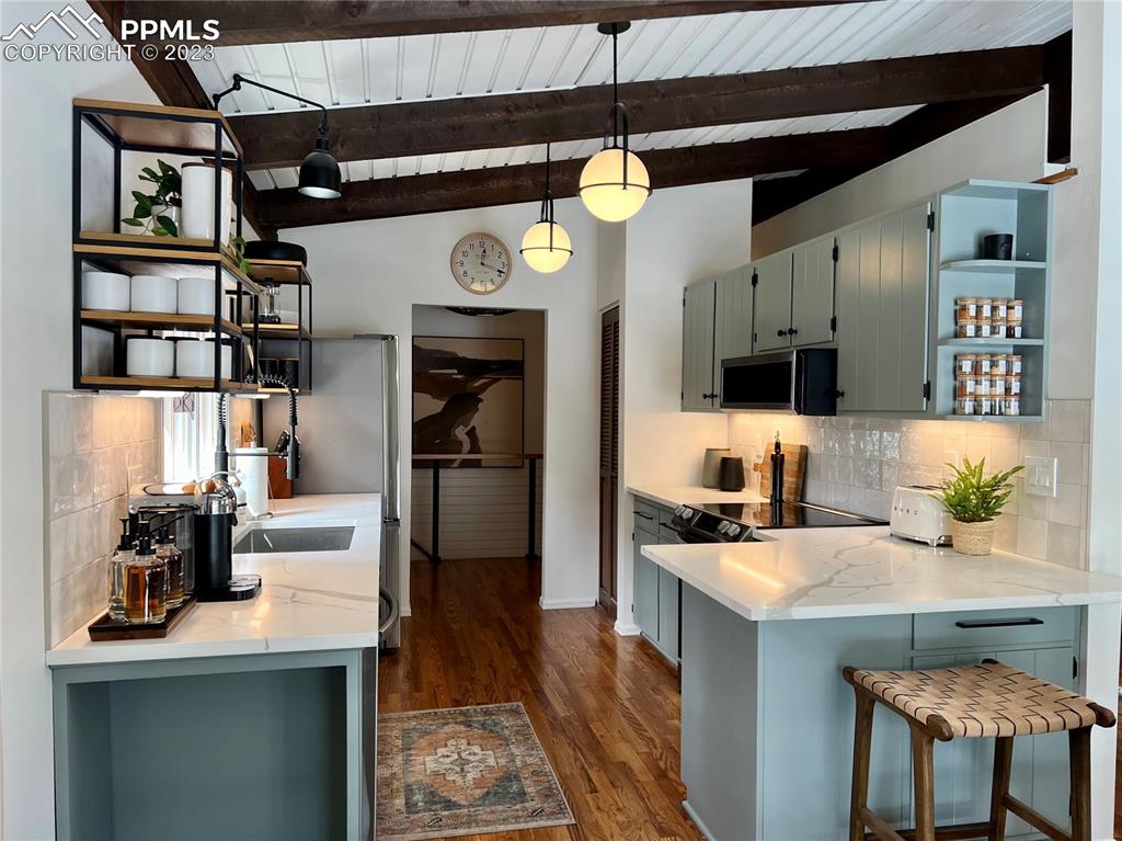 9660 Mohawk Trail Cascade, CO 80809 - Photo 16 of 43 a kitchen with a sink a refrigerator and chairs