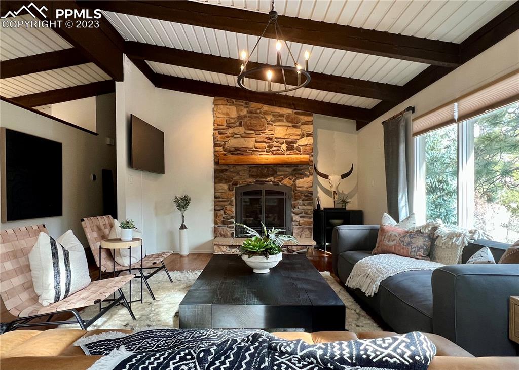9660 Mohawk Trail Cascade, CO 80809 - Photo 19 of 43 a living room with furniture a flat screen tv and a large window