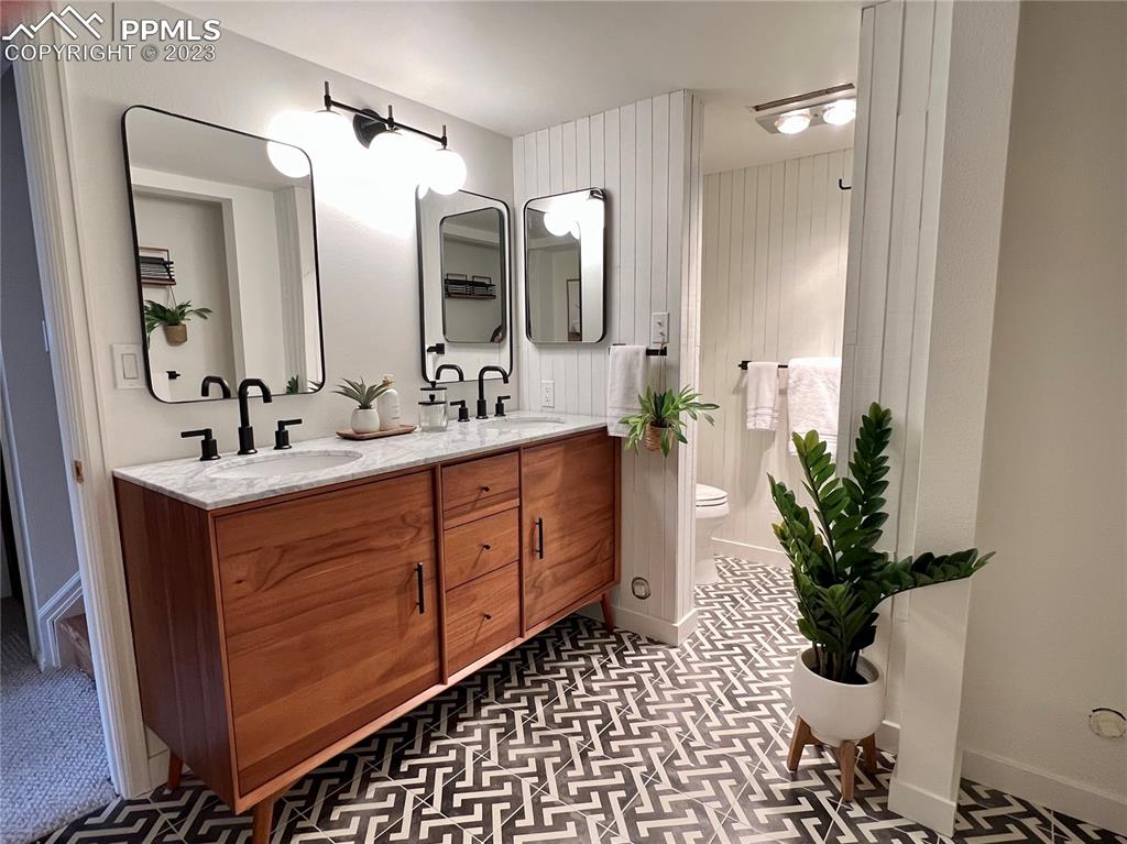 9660 Mohawk Trail Cascade, CO 80809 - Photo 31 of 43 a bathroom with a double vanity sink mirror and flower pot