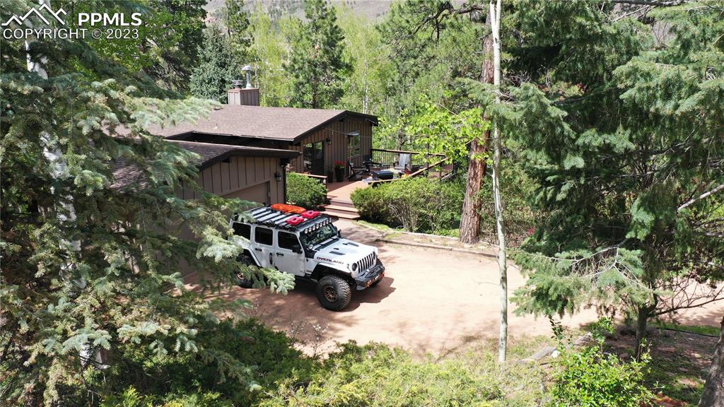 9660 Mohawk Trail Cascade, CO 80809 - Photo 39 of 43 an aerial view of a house with swimming pool and garden