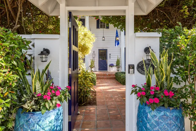 a view of a house with a small yard and plants