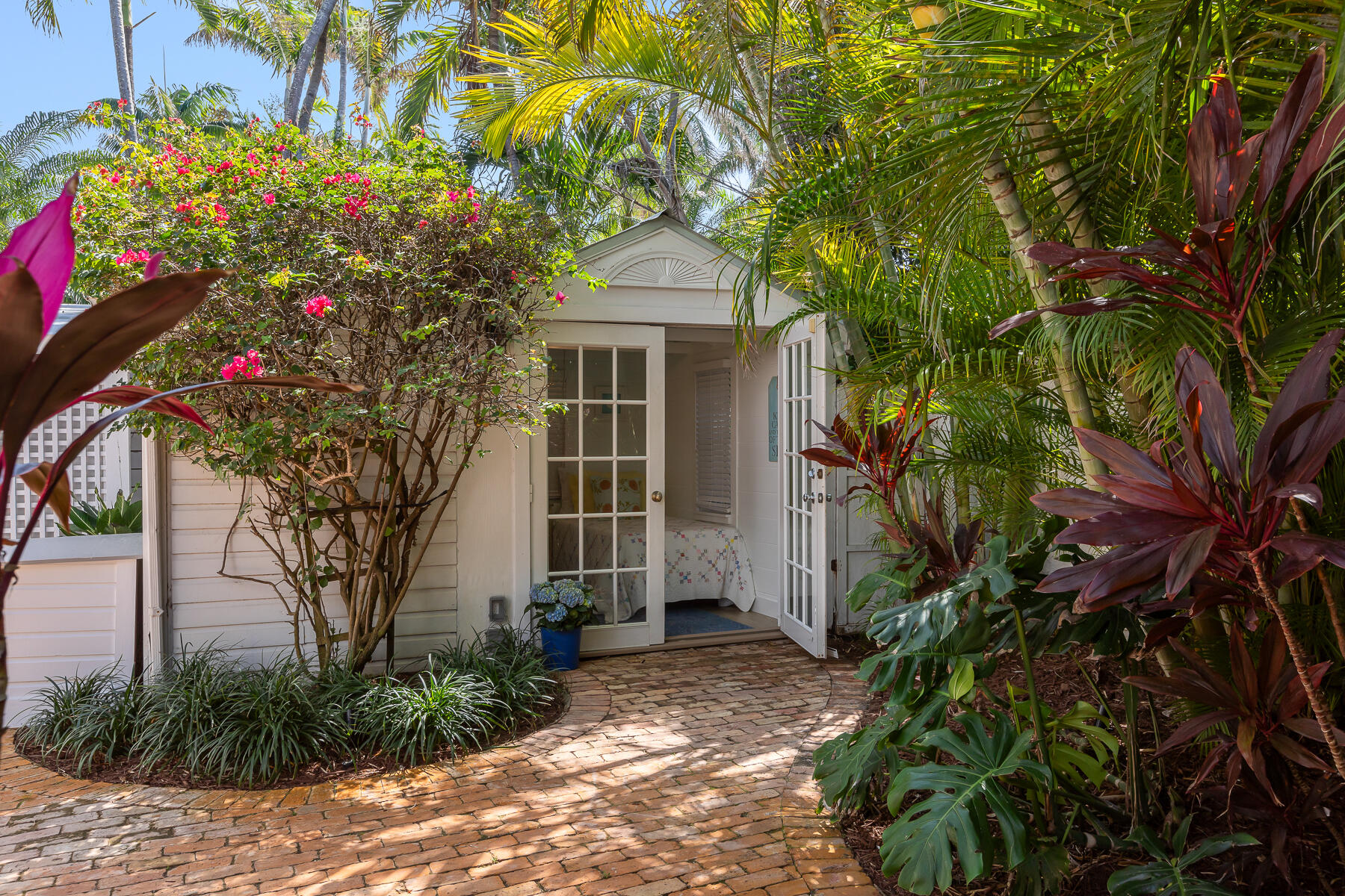 906 Johnson Street Key West, FL 33040 - Photo 47 of 65 a front view of a house with a yard and potted plants