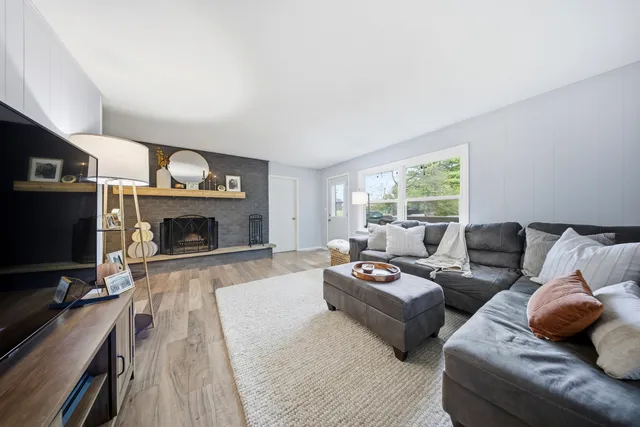 a living room with furniture flat screen tv and a fireplace