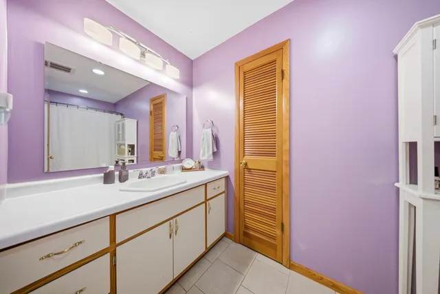 a bathroom with a sink a mirror and a shower