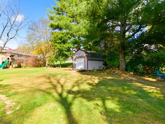 a view of a house with a yard and sitting area