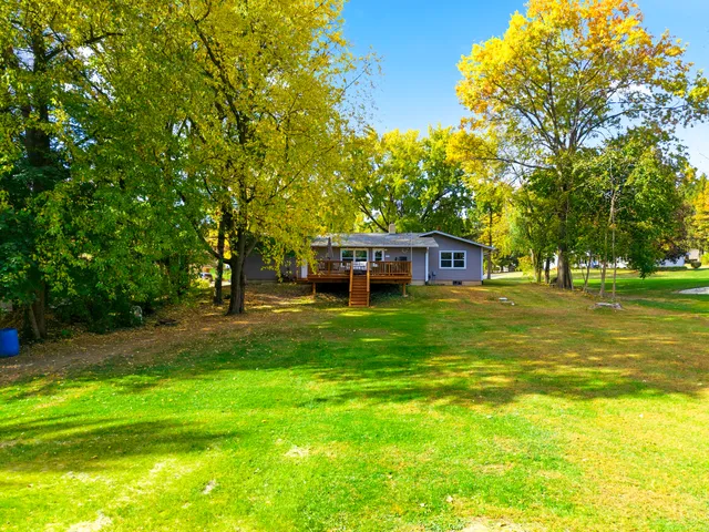 a view of a house with pool and a yard