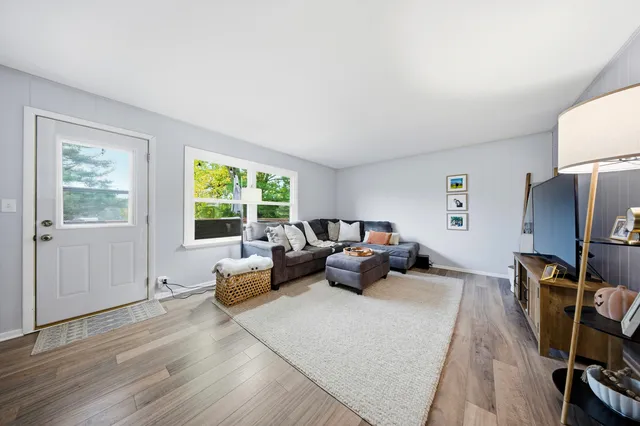 a living room with furniture window and a flat screen tv