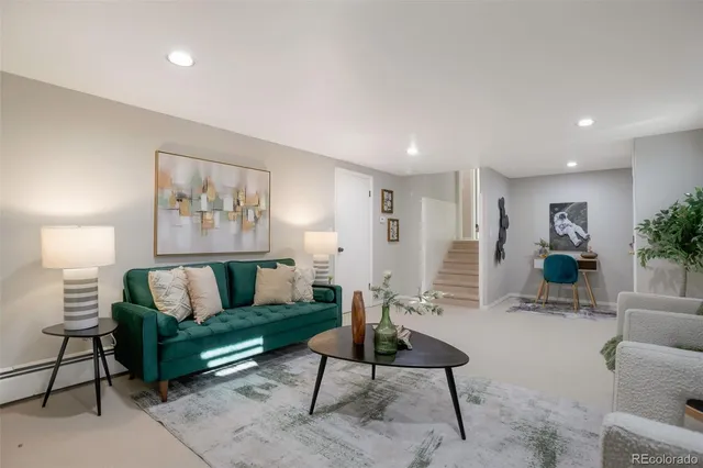 a living room with furniture and a potted plant