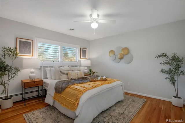 a bedroom with a bed and a potted plant