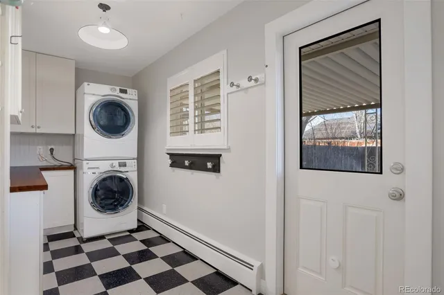 a room with a black white checkered floor and a window with wooden floor