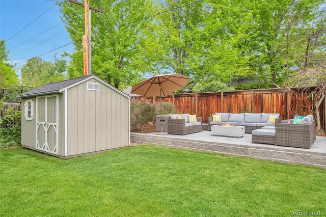 a view of backyard with deck and outdoor seating