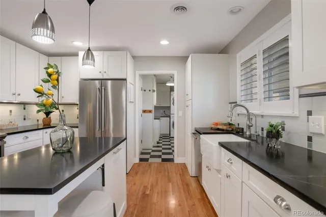a kitchen with refrigerator and sink