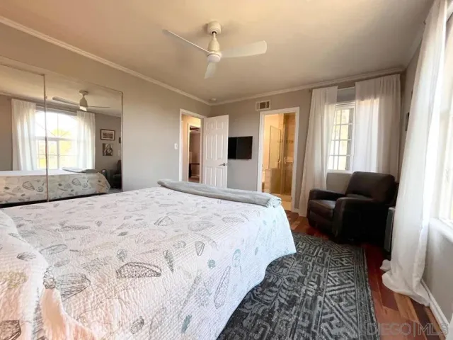 a spacious bedroom with a large bed and a couch