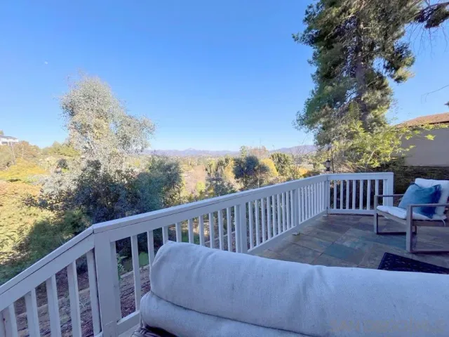 a balcony with wooden floor and outdoor space