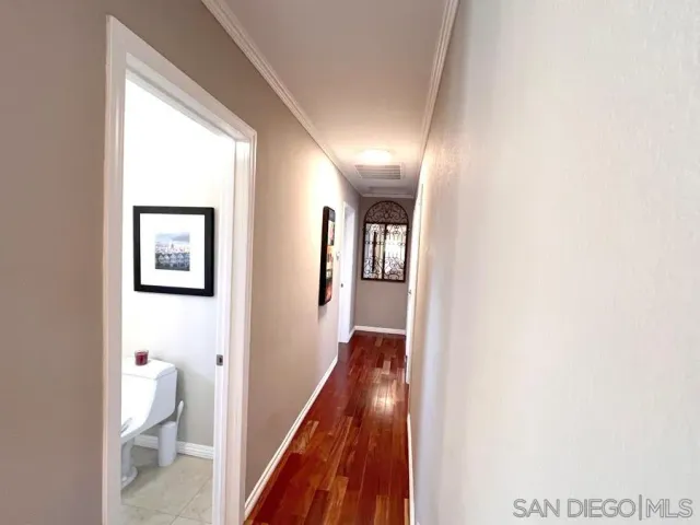 a view of a hallway with a white walls and a floor to ceiling window