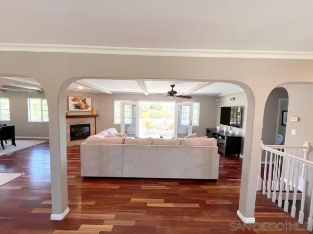 a living room with fireplace furniture and a wooden floor