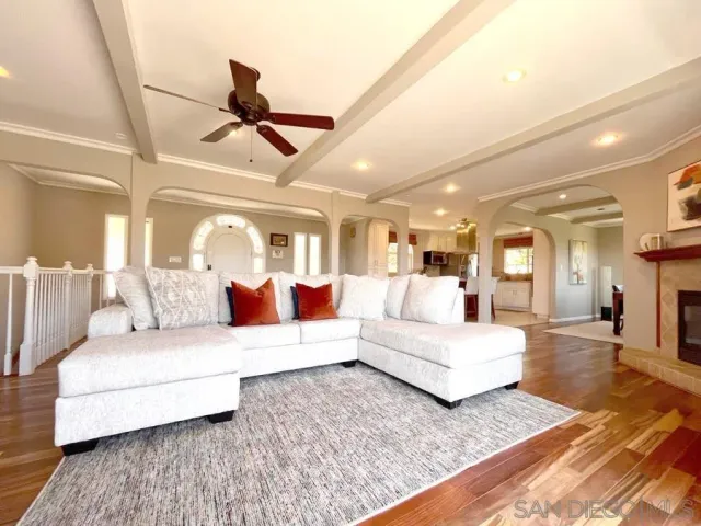 a living room with furniture and a ceiling fan