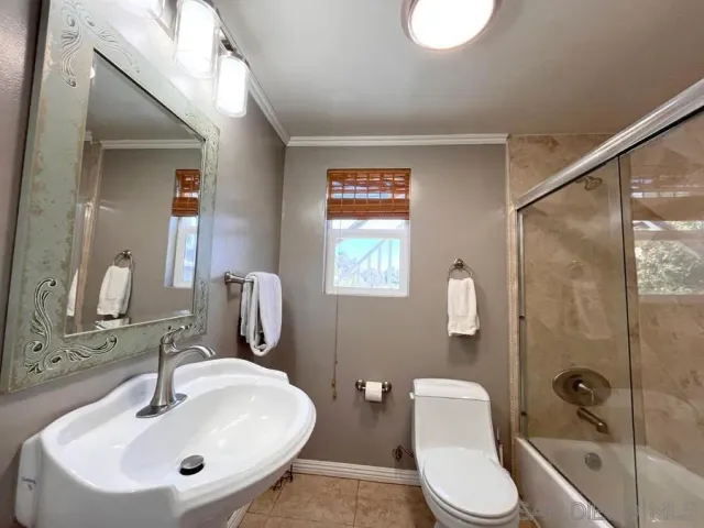 a bathroom with a toilet sink and shower