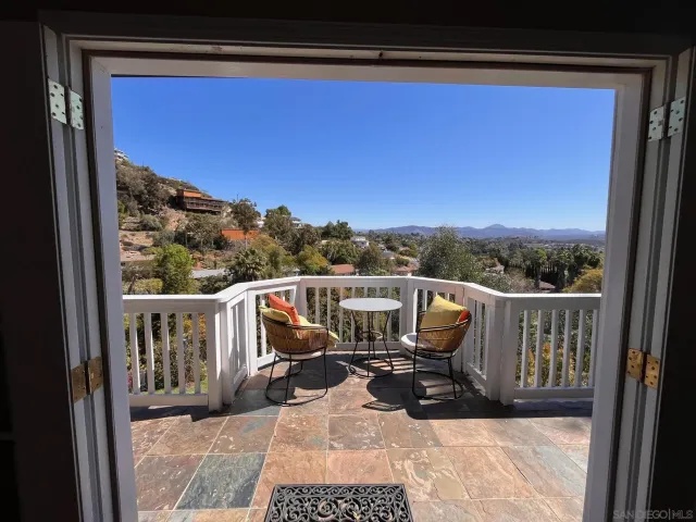 a bathroom with a granite countertop shower and a toilet