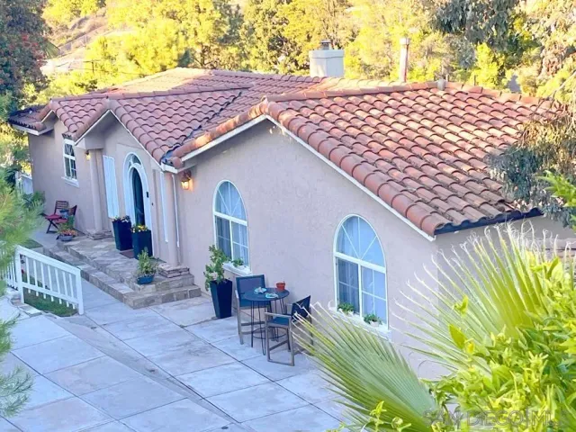 a bathroom with a toilet a sink and a glass door shower