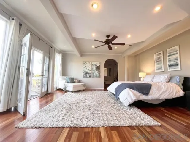 a bedroom with a large bed and a window