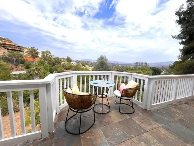 a view of a patio with a table and chairs