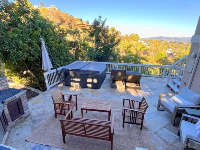 a view of a patio with table and chairs and wooden floor