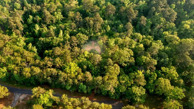 a sign board with a play ground in the back