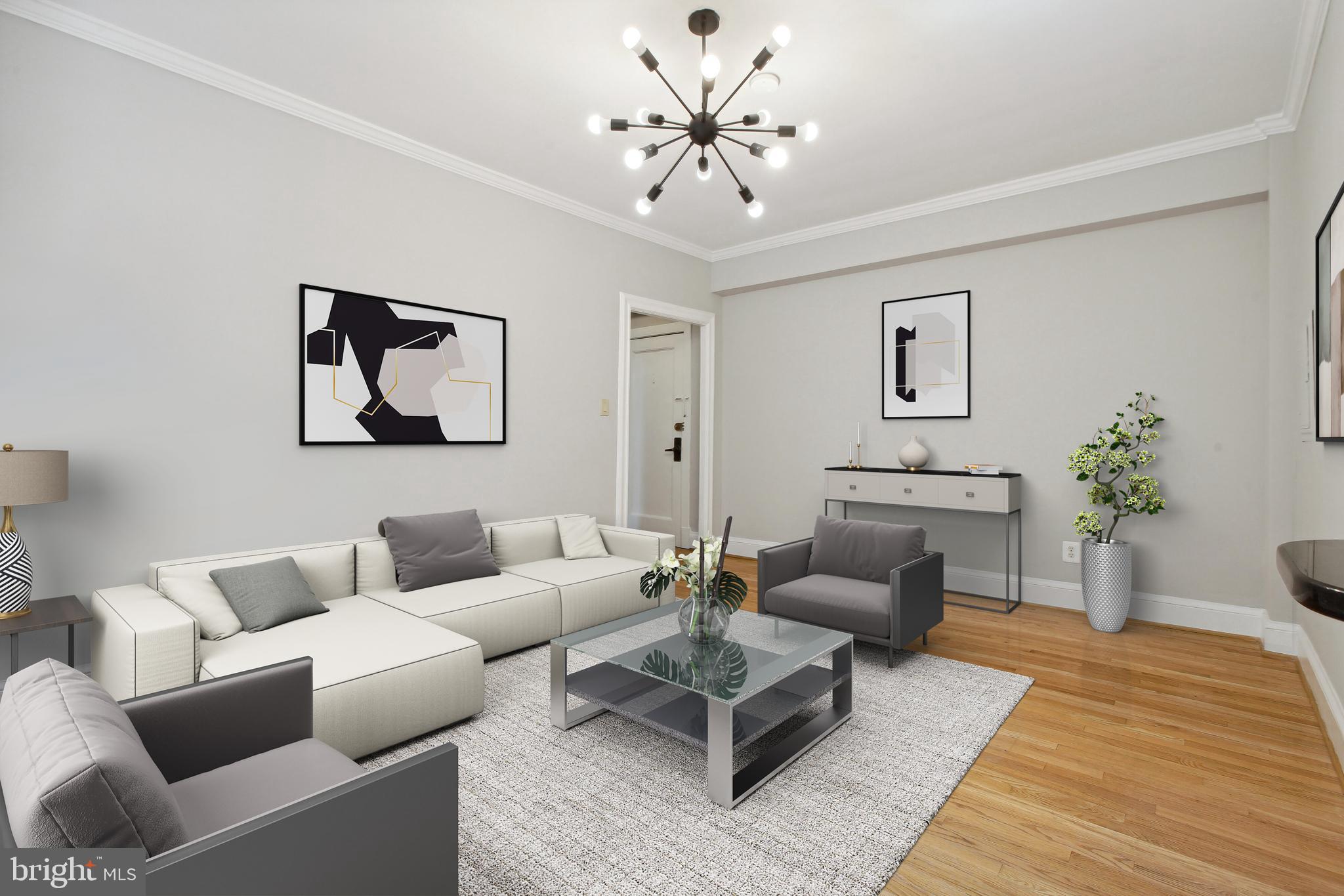 a living room with furniture and a chandelier