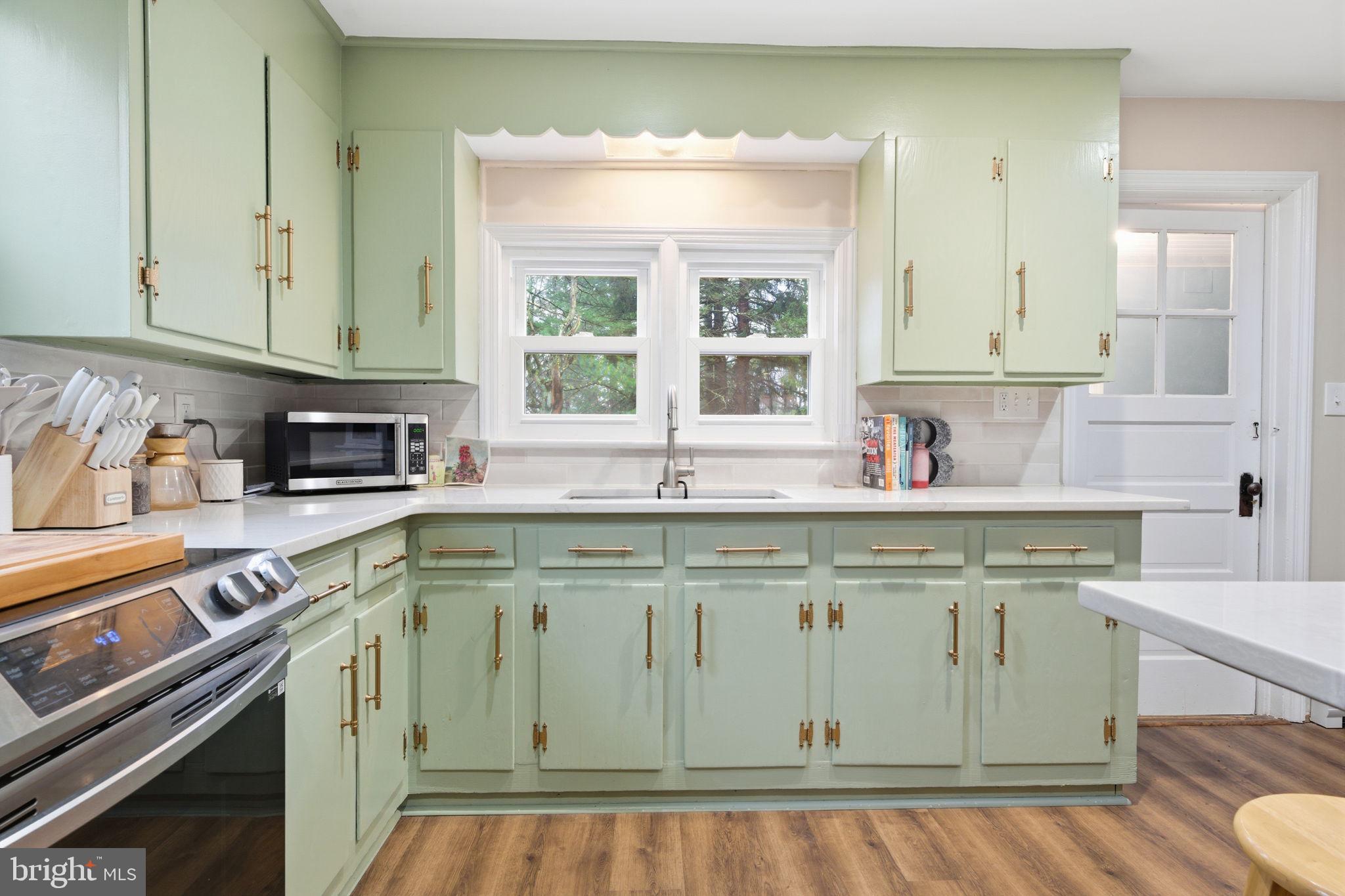 131 Crusher Road Hopewell, NJ 08525 - Photo 12 of 41 a kitchen with stainless steel appliances granite countertop a sink a stove and a wooden cabinets