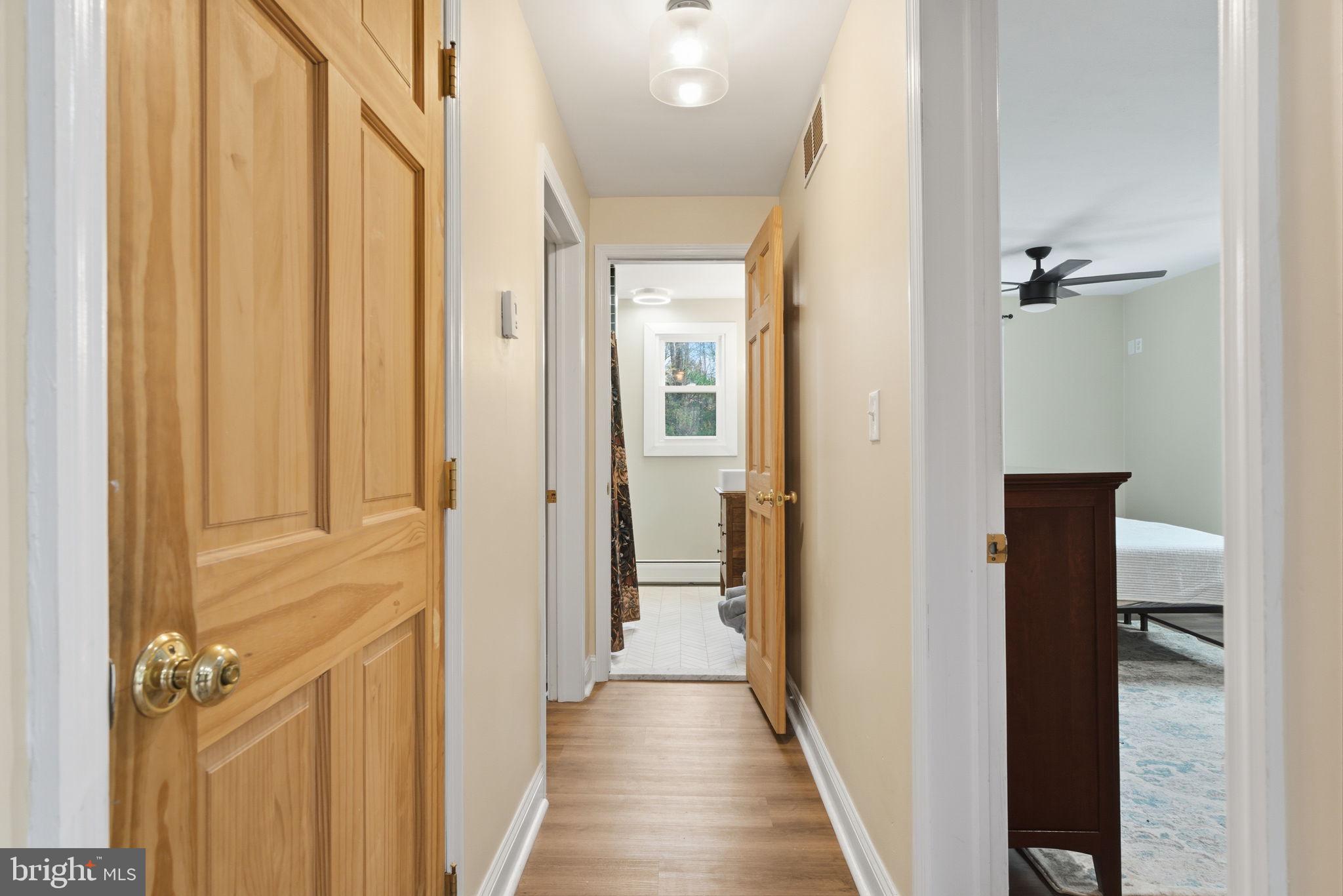 131 Crusher Road Hopewell, NJ 08525 - Photo 18 of 41 a view of a hallway with wooden floor and staircase