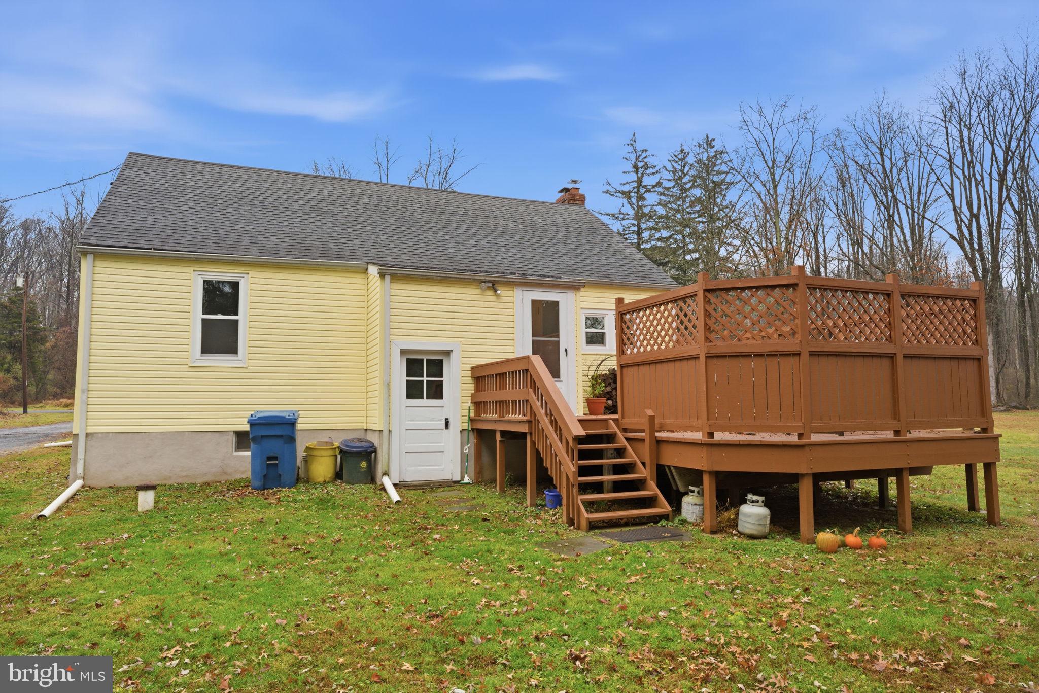 131 Crusher Road Hopewell, NJ 08525 - Photo 40 of 41 a backyard of a house with barbeque oven and wooden fence