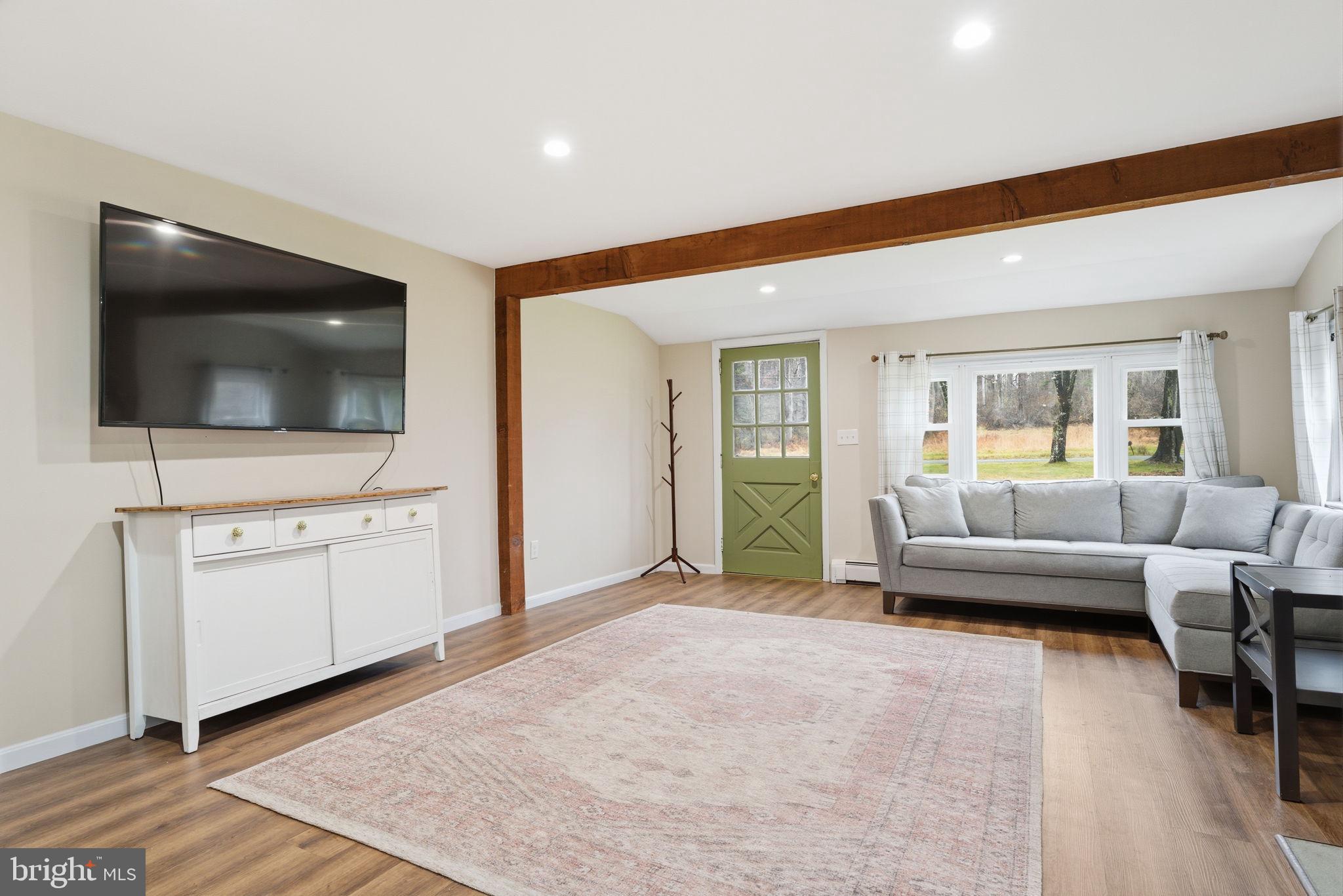 131 Crusher Road Hopewell, NJ 08525 - Photo 8 of 41 a living room with furniture and a flat screen tv